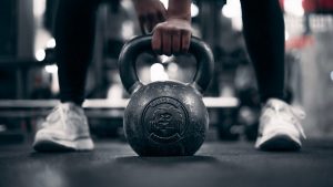 a person holding a kettle in a gym